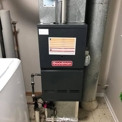 A newly installed Goodman gas furnace with new gas and flue connections.